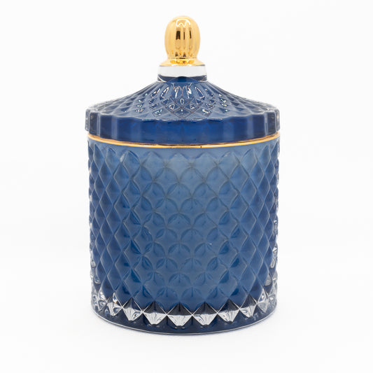 Gloss cut glass blue and gold candle, with lid on.