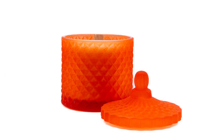 Lid removed and placed next to candle, wooden wick showing, matt orange design.
