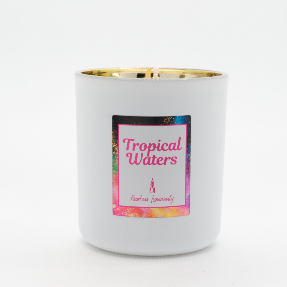 White candle, with gold inner, cotton wick and in Tropical Waters fragrance. 