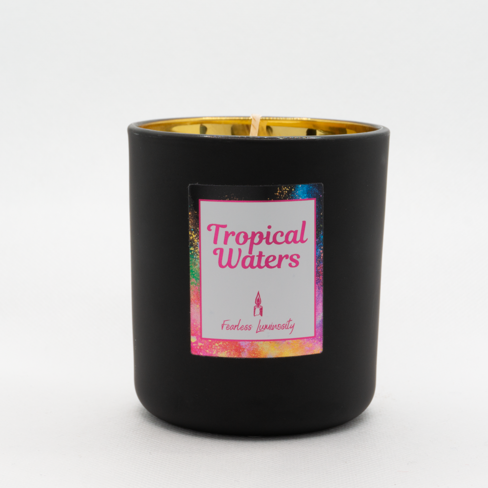 Black outer Candle with gold reflective inner candle and Tropical Water fragrance. Cotton Wick. 