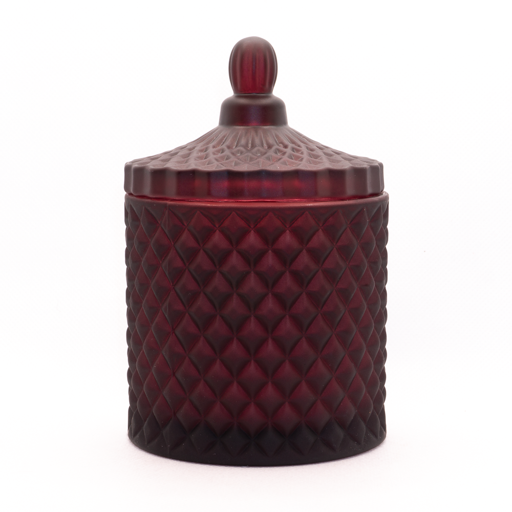Burgundy candle, cut glass design with lid on. 
