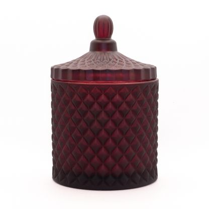 Burgundy candle, cut glass design with lid on. 