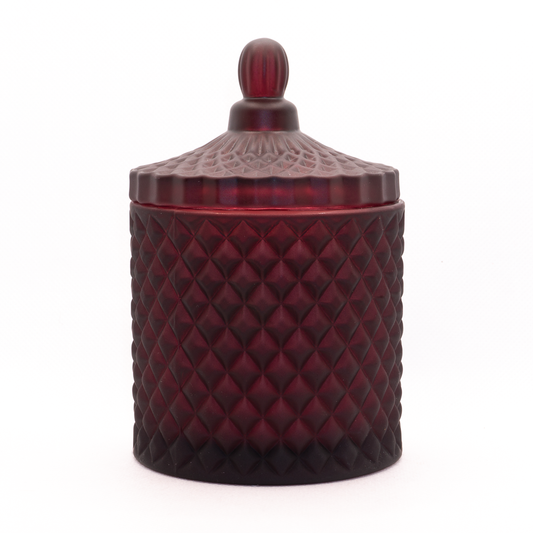 Burgundy candle, cut glass design with lid on. 